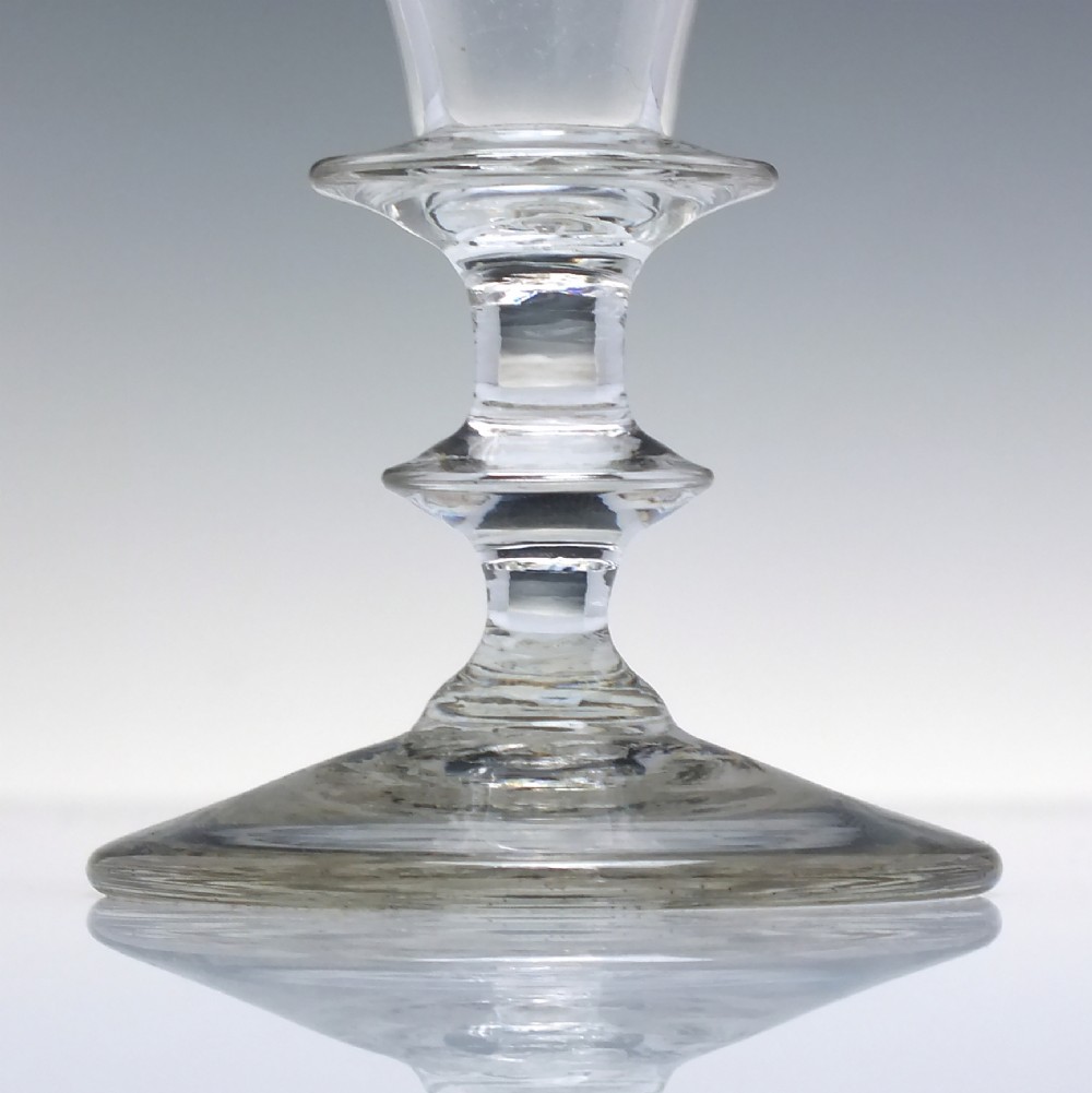 A pair of clear hand-blown Georgian glass goblets featuring wheel-engraved motifs of hops and barley on conical bowls above knopped stems and conical bases. View IV