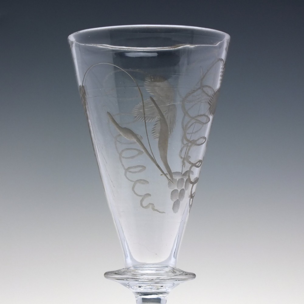 A pair of clear hand-blown Georgian glass goblets featuring wheel-engraved motifs of hops and barley on conical bowls above knopped stems and conical bases. View VIII