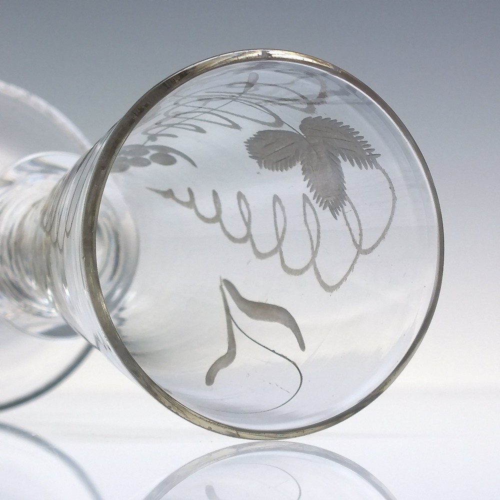 A pair of clear hand-blown Georgian glass goblets featuring wheel-engraved motifs of hops and barley on conical bowls above knopped stems and conical bases. View IX