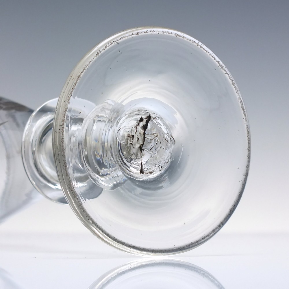A pair of clear hand-blown Georgian glass goblets featuring wheel-engraved motifs of hops and barley on conical bowls above knopped stems and conical bases. View X
