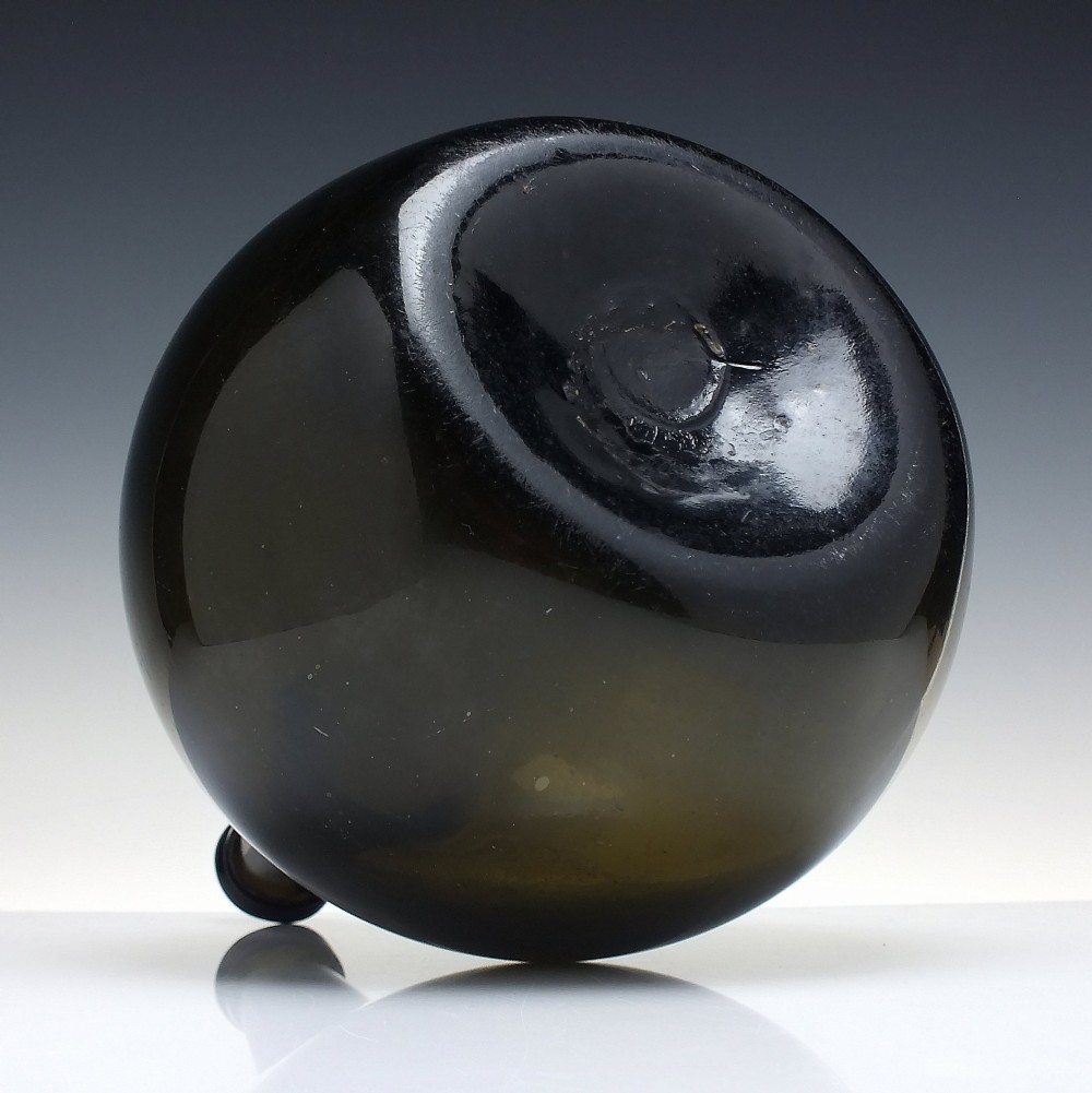 A large, dark green hand-blown antique glass wine bottle with a bulbous body and tapered neck. View IV
