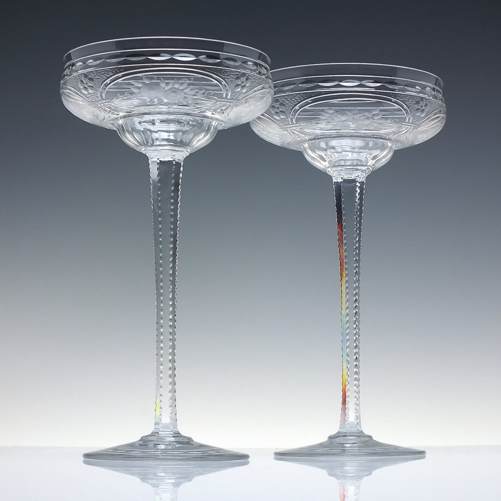 A set of six French Art Nouveau clear lead crystal champagne coupes with tall beaded stems and etched floral motifs on shallow bowls. View II