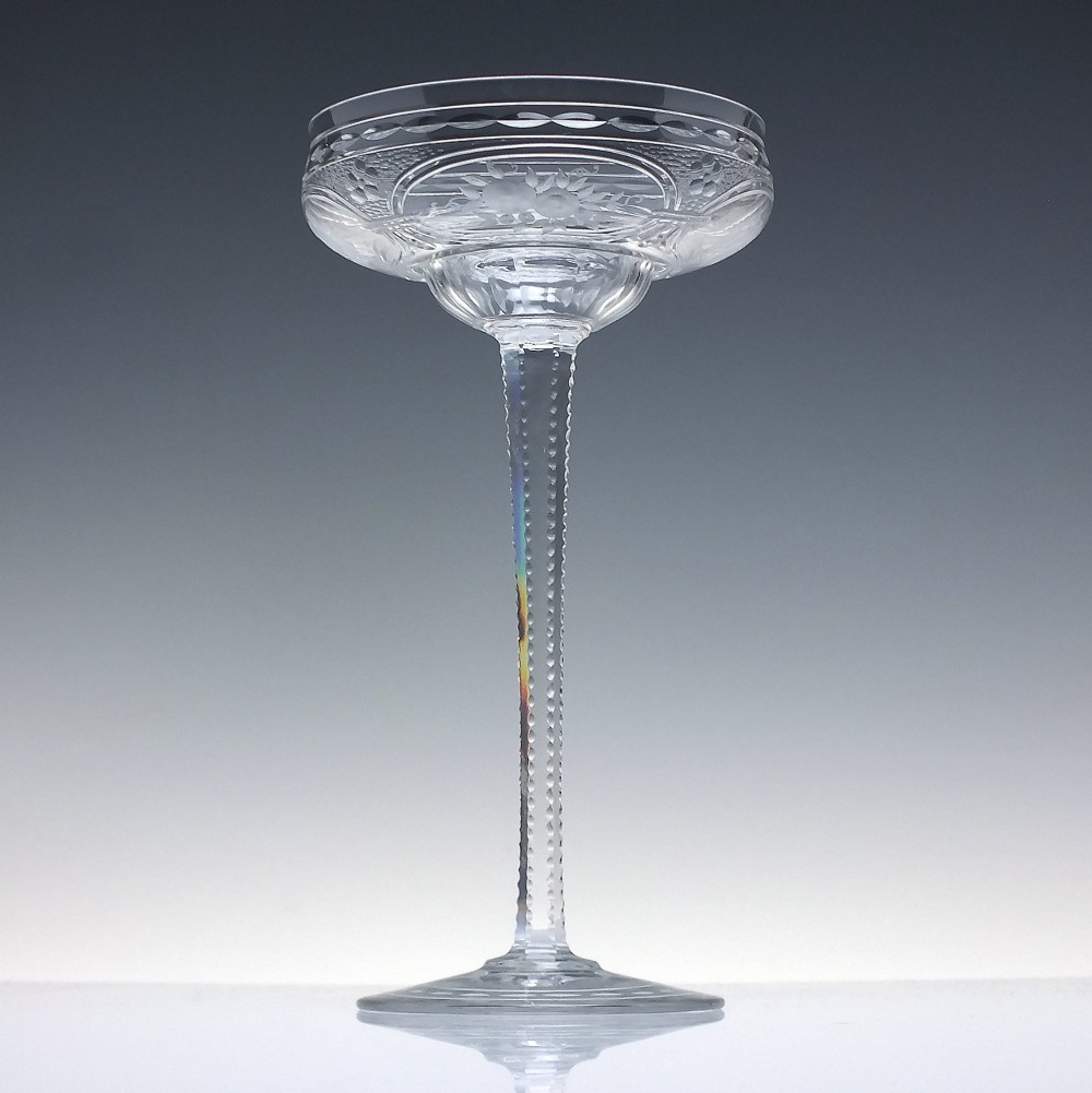 A set of six French Art Nouveau clear lead crystal champagne coupes with tall beaded stems and etched floral motifs on shallow bowls. View III