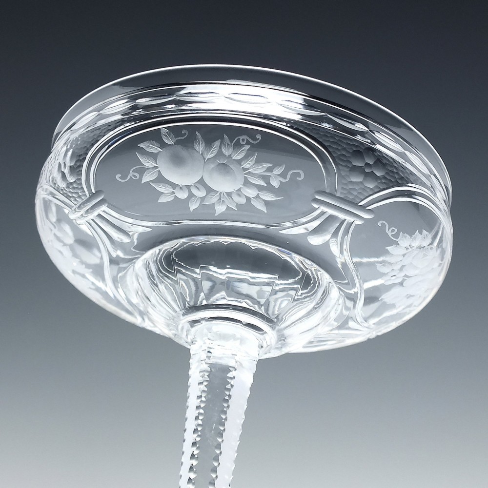A set of six French Art Nouveau clear lead crystal champagne coupes with tall beaded stems and etched floral motifs on shallow bowls. View V
