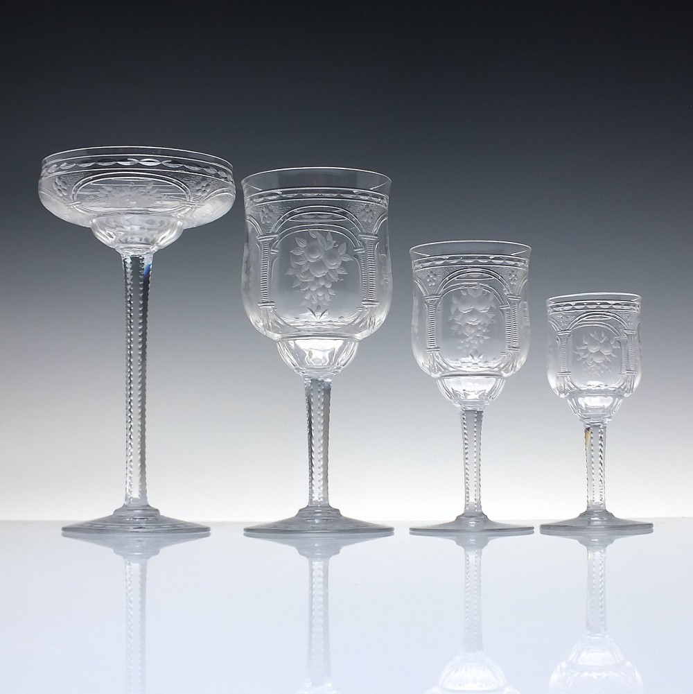 A set of six French Art Nouveau clear lead crystal champagne coupes with tall beaded stems and etched floral motifs on shallow bowls. View VI