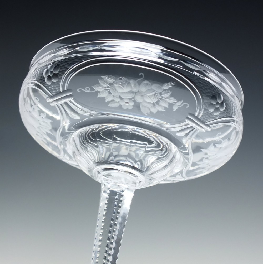 A set of six French Art Nouveau clear lead crystal champagne coupes with tall beaded stems and etched floral motifs on shallow bowls. View VII