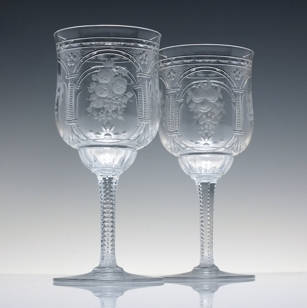 A set of six clear lead crystal wine glasses featuring intricate acid-etched floral panels and textured facet-cut stems. View II