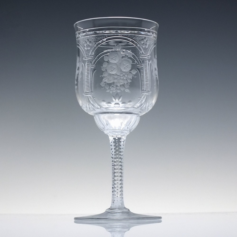A set of six clear lead crystal wine glasses featuring intricate acid-etched floral panels and textured facet-cut stems. View III