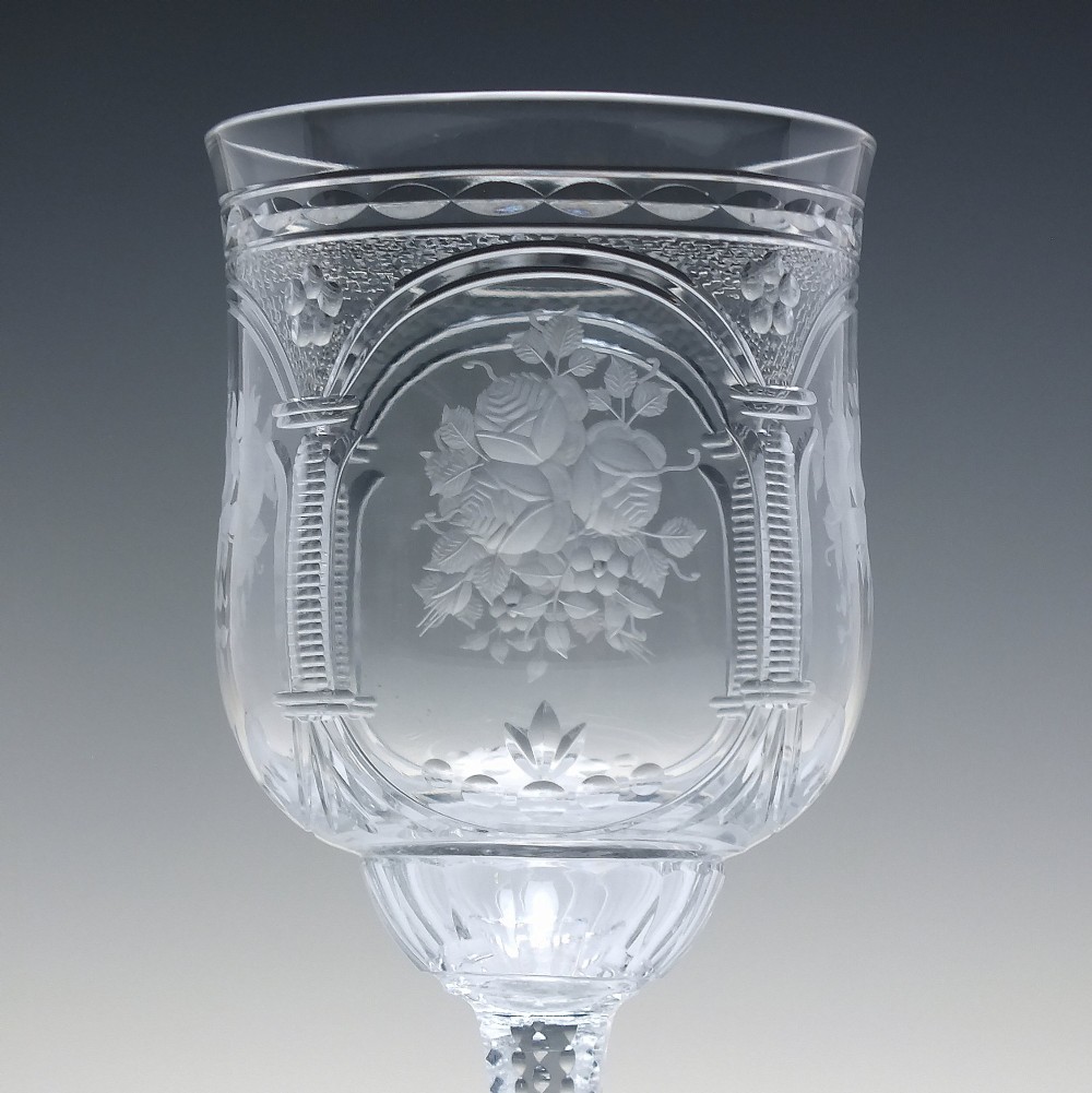 A set of six clear lead crystal wine glasses featuring intricate acid-etched floral panels and textured facet-cut stems. View IV