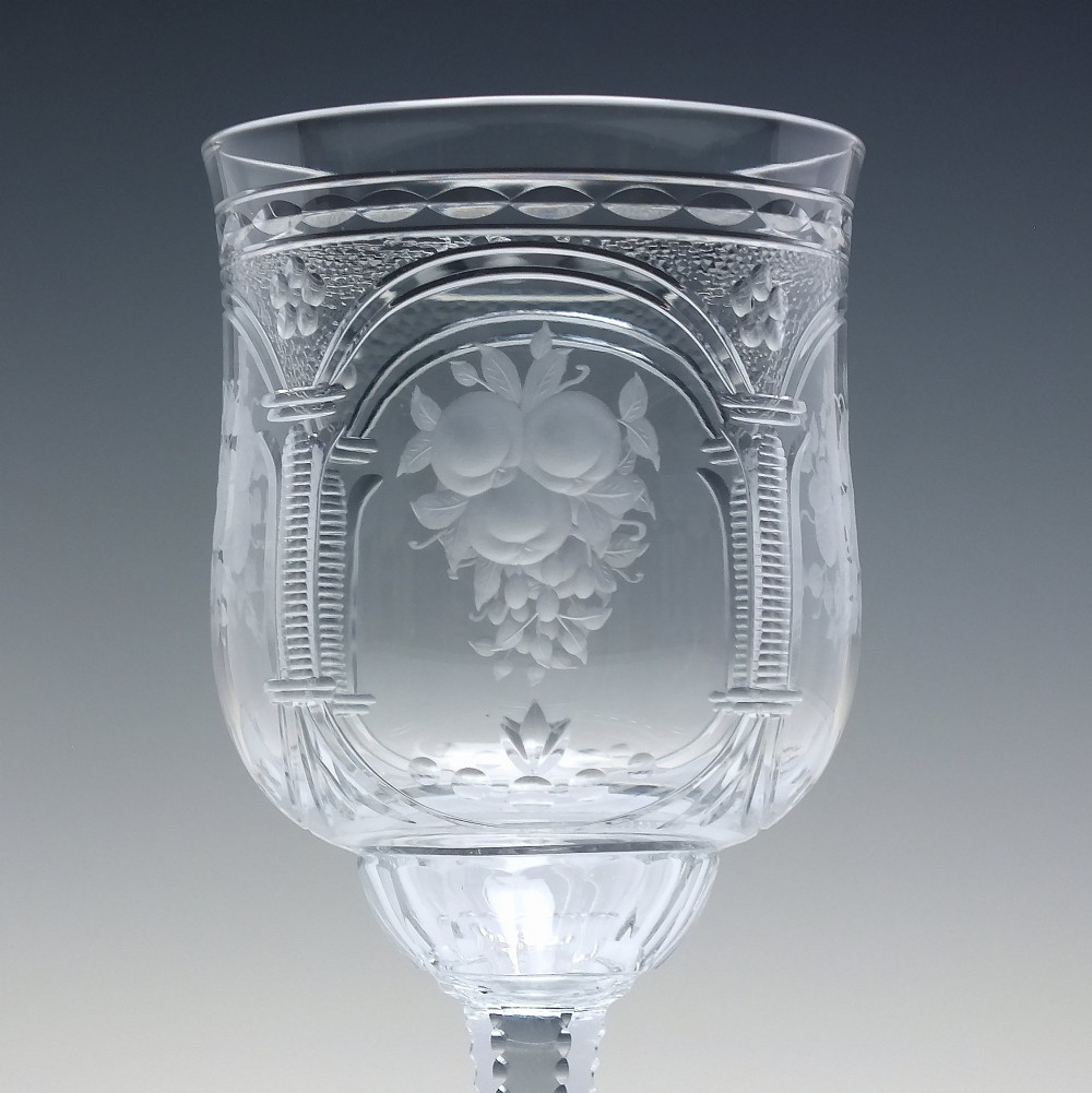 A set of six clear lead crystal wine glasses featuring intricate acid-etched floral panels and textured facet-cut stems. View V