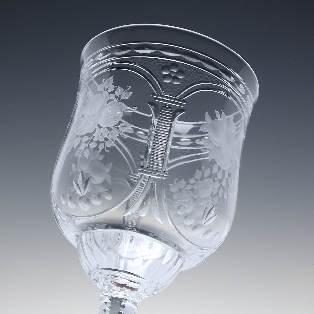 A set of six clear lead crystal wine glasses featuring intricate acid-etched floral panels and textured facet-cut stems. View VIII