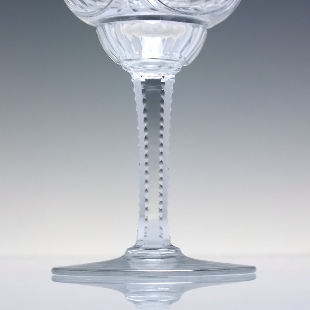 A set of six clear lead crystal wine glasses featuring intricate acid-etched floral panels and textured facet-cut stems. View IX