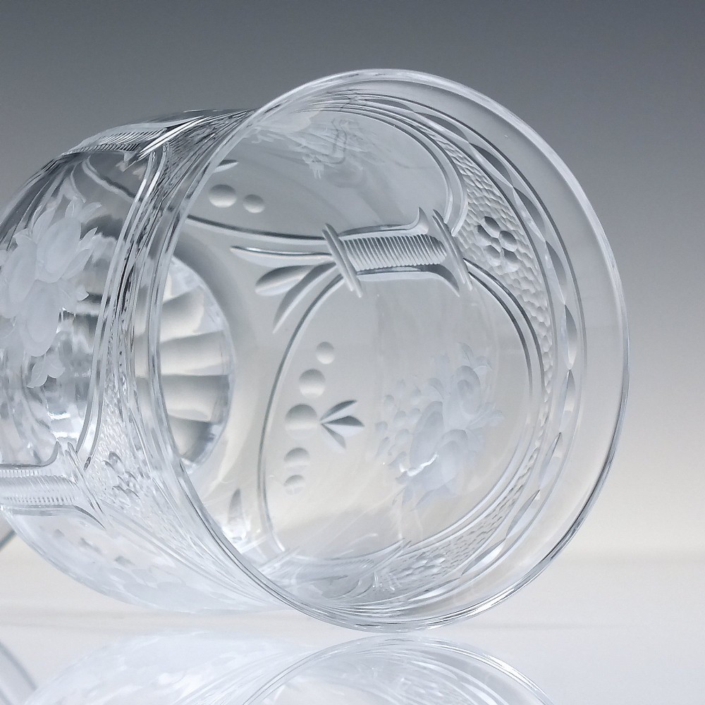 A set of six clear lead crystal wine glasses featuring intricate acid-etched floral panels and textured facet-cut stems. View X
