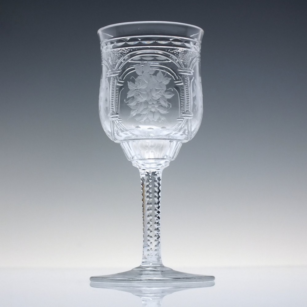 A set of six clear lead crystal dram glasses featuring acid-etched floral panels set within archways and faceted diamond-cut stems. View III