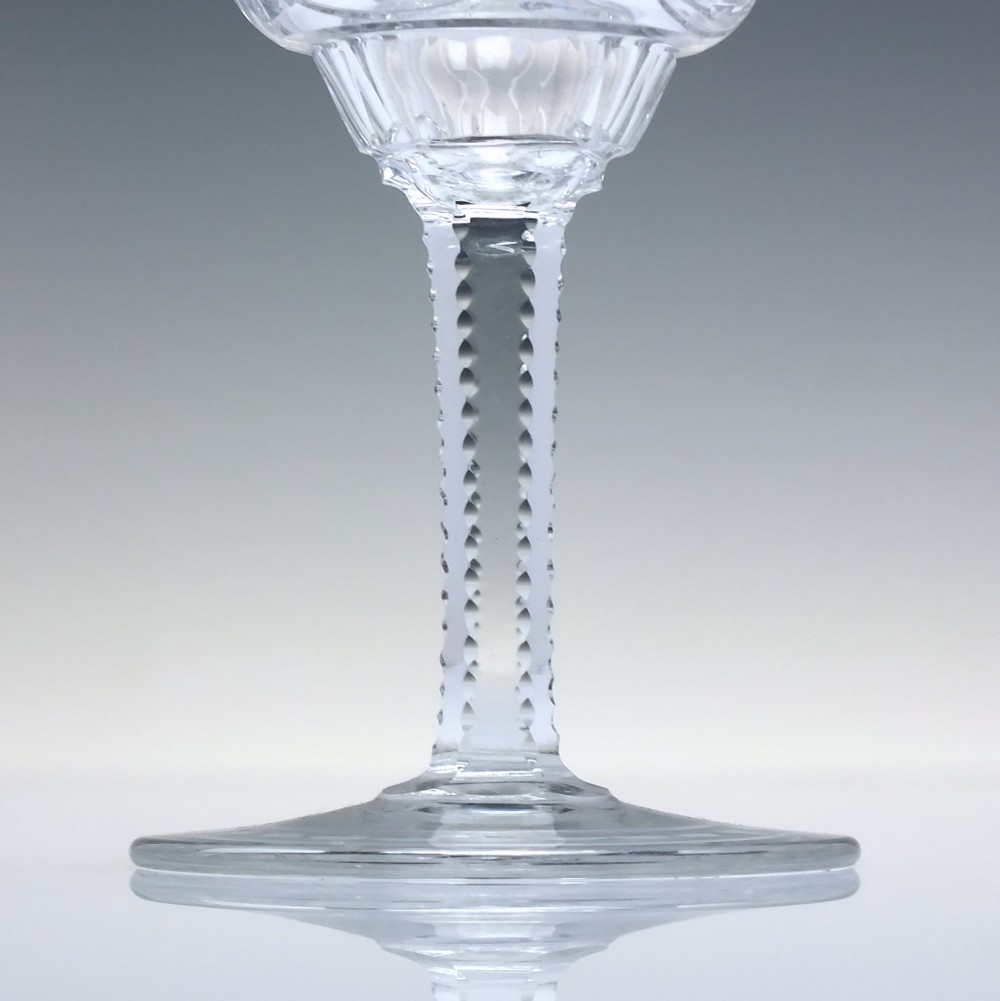 A set of six clear lead crystal dram glasses featuring acid-etched floral panels set within archways and faceted diamond-cut stems. View IV