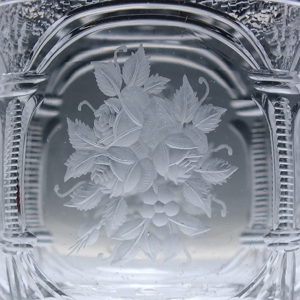 A set of six clear lead crystal dram glasses featuring acid-etched floral panels set within archways and faceted diamond-cut stems. View VI