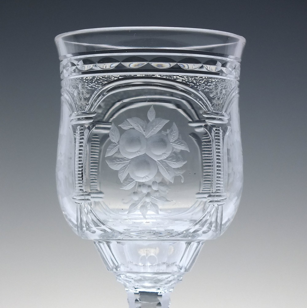 A set of six clear lead crystal dram glasses featuring acid-etched floral panels set within archways and faceted diamond-cut stems. View VII