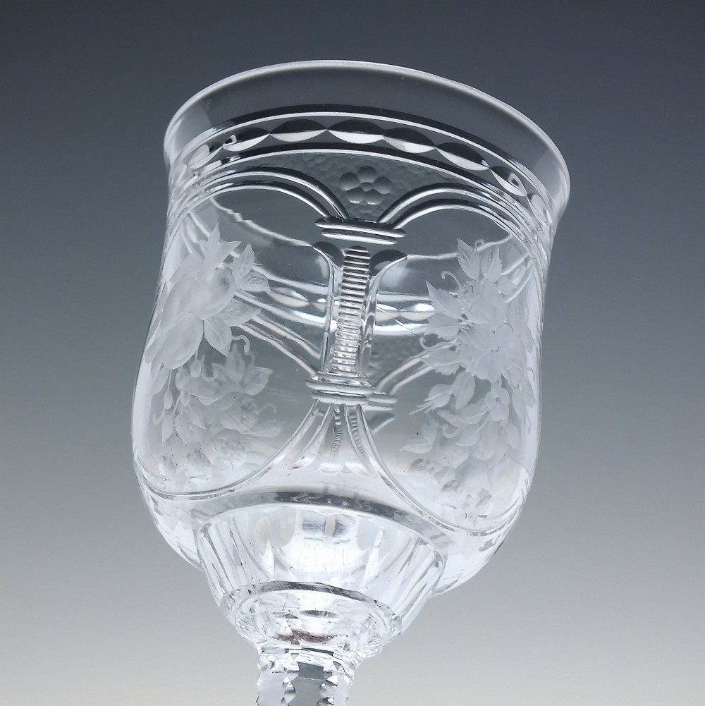 A set of six clear lead crystal dram glasses featuring acid-etched floral panels set within archways and faceted diamond-cut stems. View IX