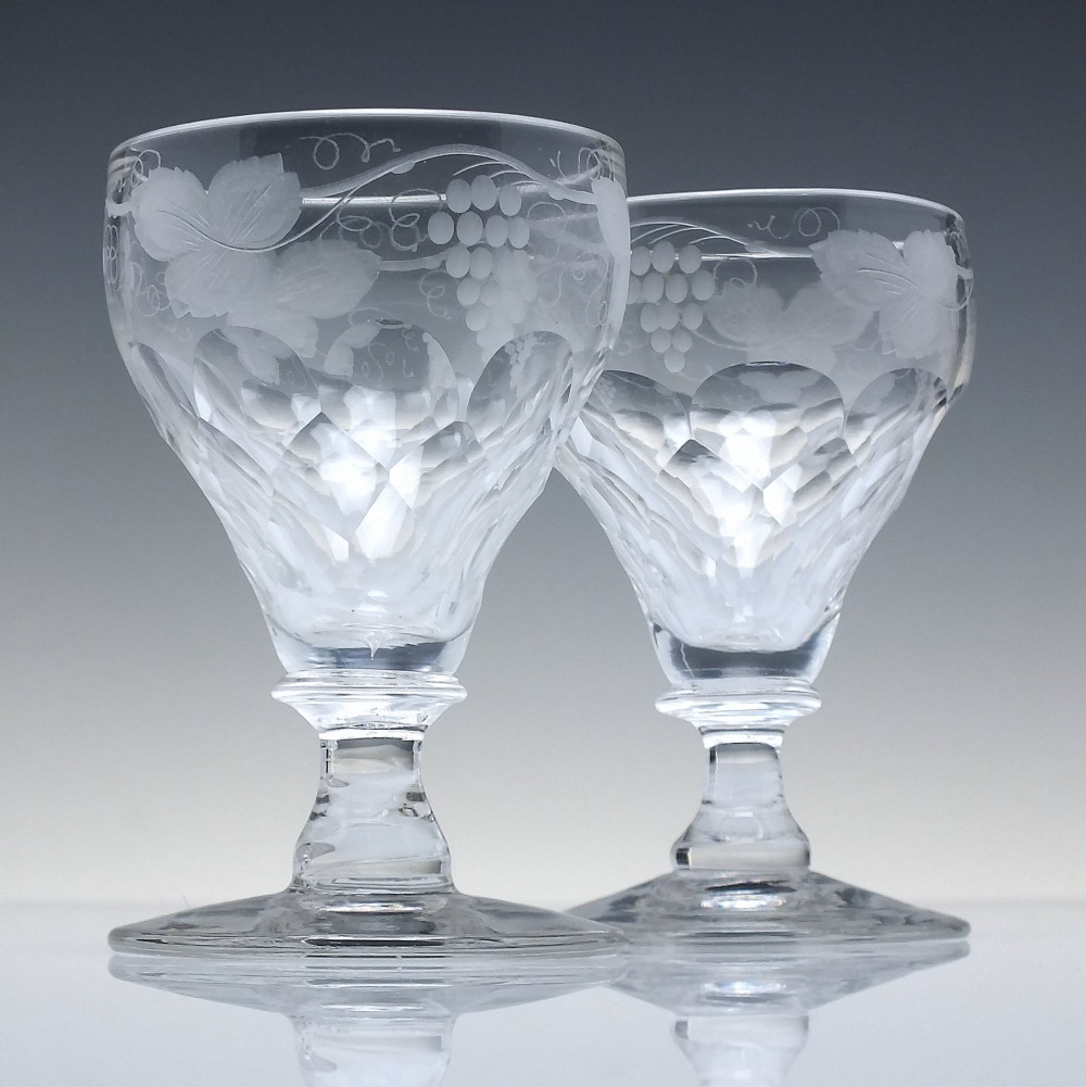 A set of six vintage clear glass port goblets featuring wheel-engraved grapevine motifs on pan-topped bowls with cut facet details. View II
