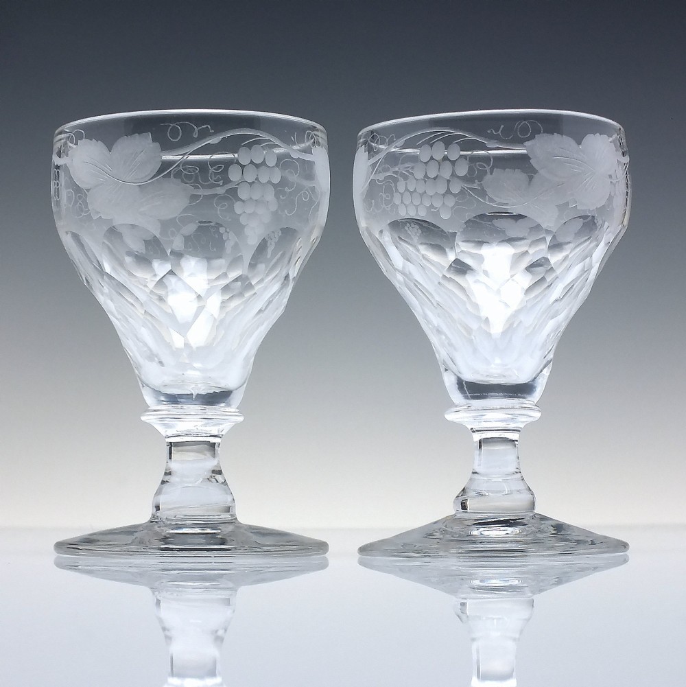 A set of six vintage clear glass port goblets featuring wheel-engraved grapevine motifs on pan-topped bowls with cut facet details. View III