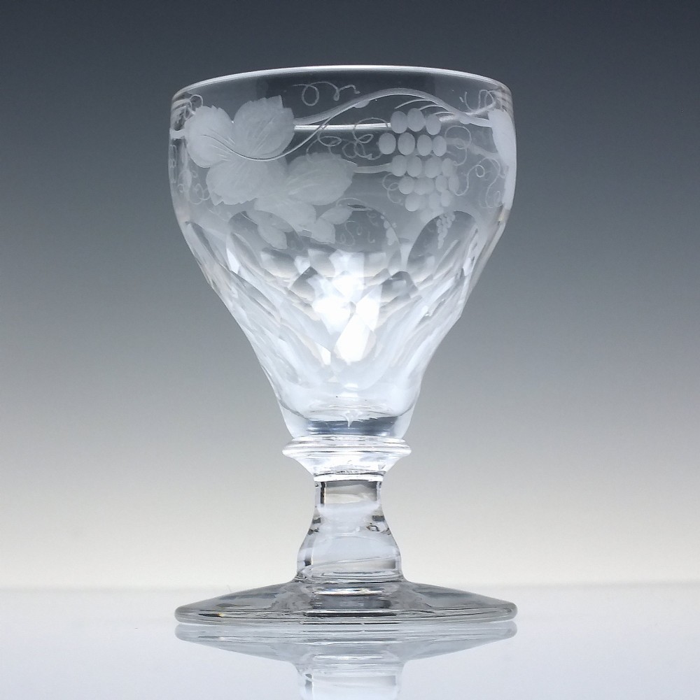 A set of six vintage clear glass port goblets featuring wheel-engraved grapevine motifs on pan-topped bowls with cut facet details. View IV