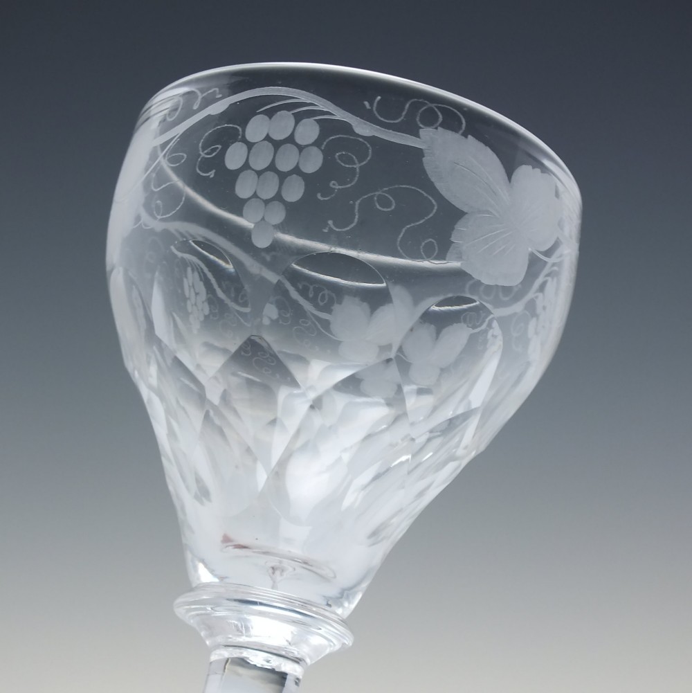 A set of six vintage clear glass port goblets featuring wheel-engraved grapevine motifs on pan-topped bowls with cut facet details. View VI