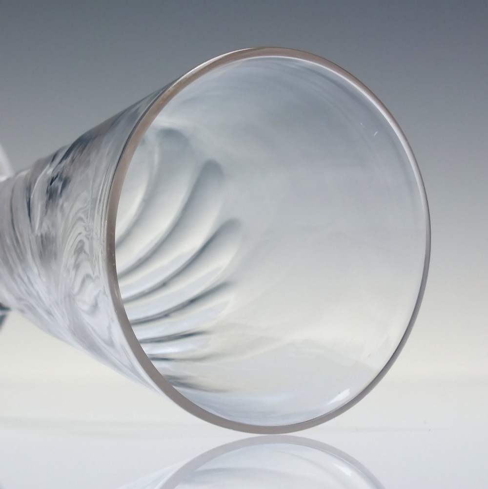 A clear Georgian ale glass featuring half-wrythen spiral moulding on the conical bowl above a knopped stem. View IV