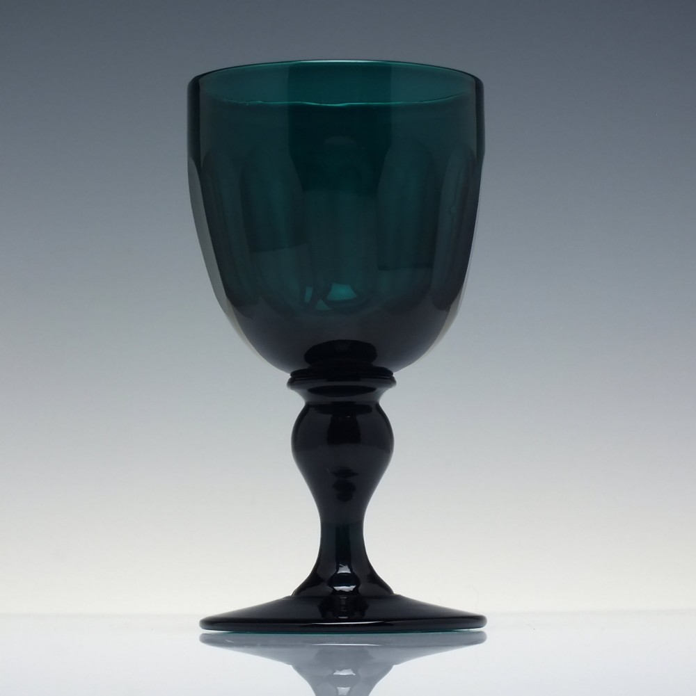 An early 19th-century turquoise green glass wine goblet featuring a cut bowl and a knopped stem on a flat circular base. View II