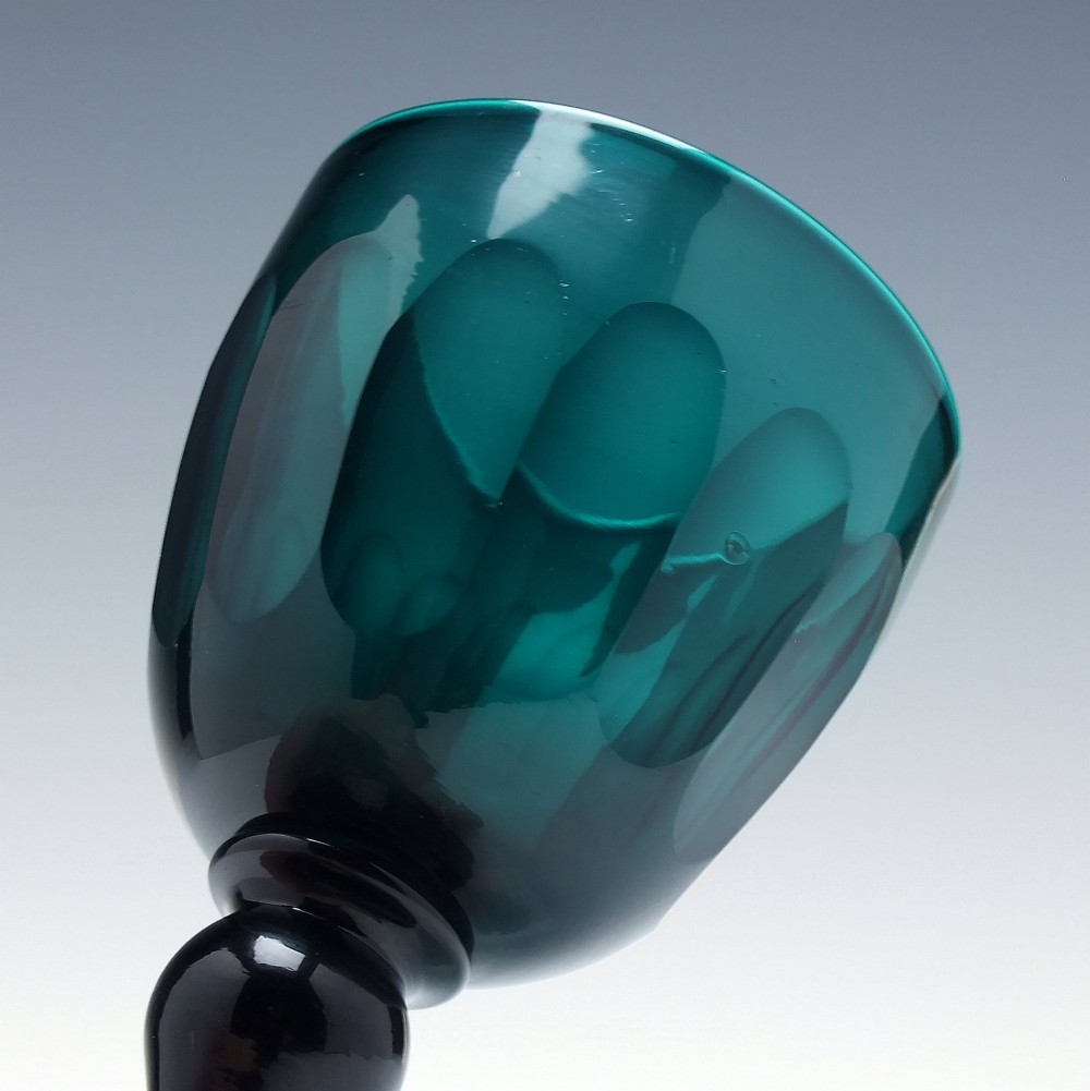 An early 19th-century turquoise green glass wine goblet featuring a cut bowl and a knopped stem on a flat circular base. View III