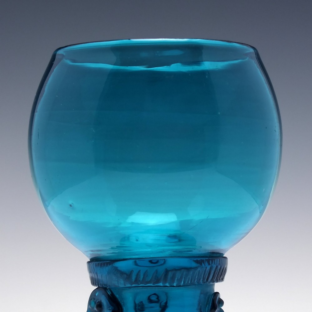 A pair of early 19th-century peacock blue glass roemers with globular bowls, prunted stems, and broad coiled pedestals. View IV