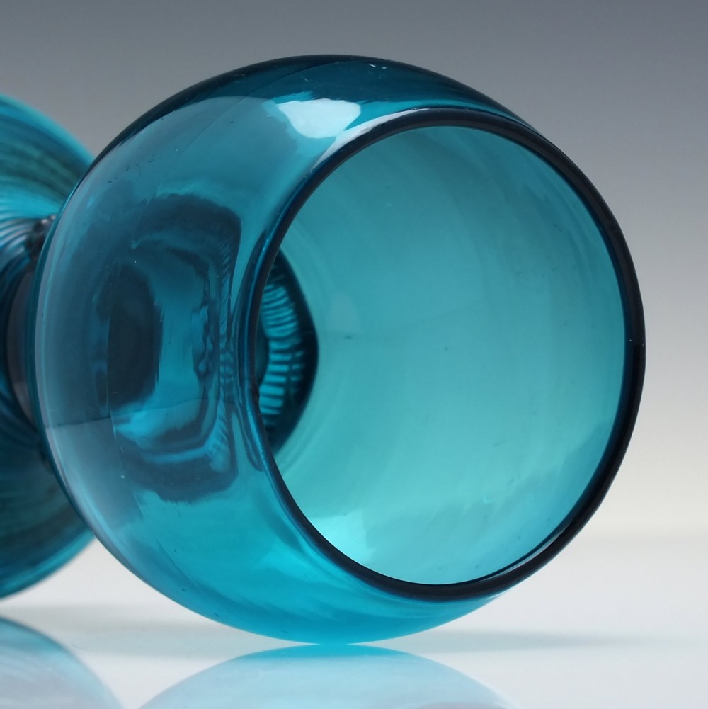 A pair of early 19th-century peacock blue glass roemers with globular bowls, prunted stems, and broad coiled pedestals. View VI