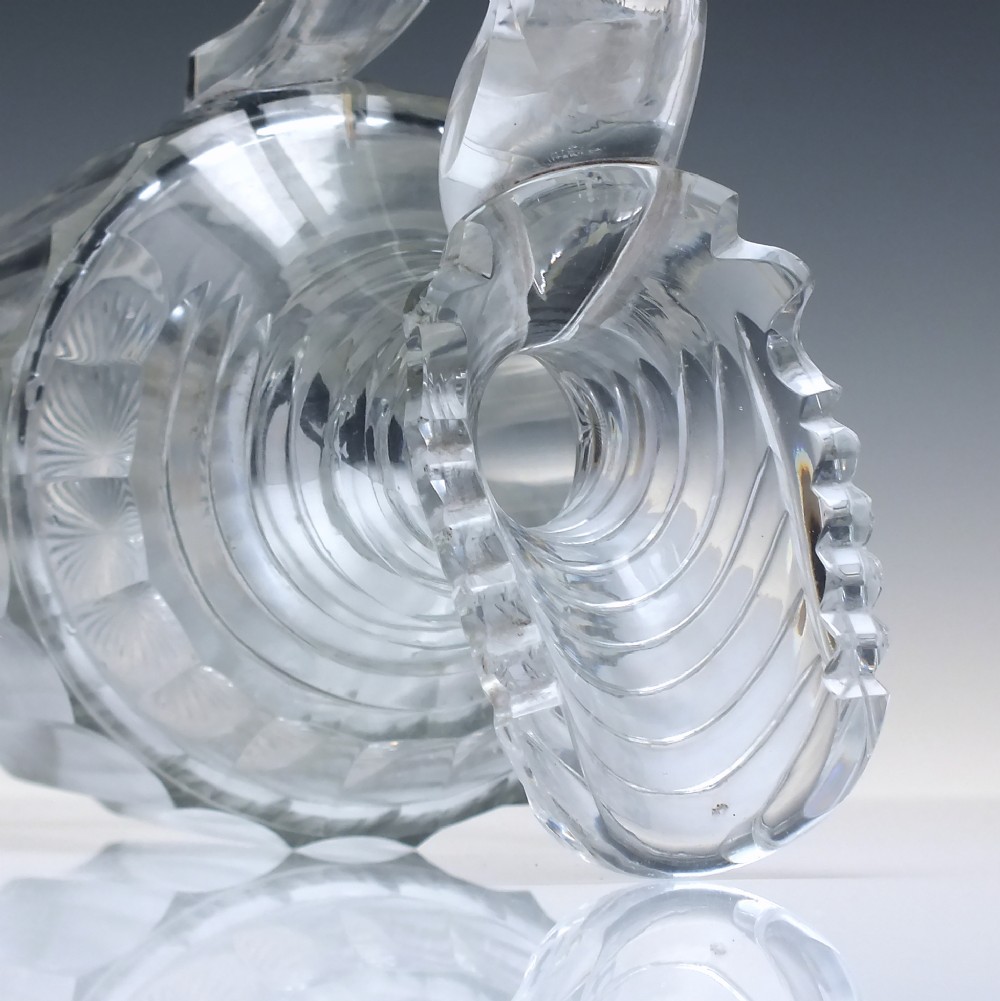 A clear Georgian Regency cut glass claret jug with a step-cut neck, panelled body, applied handle, and faceted stopper. View VII