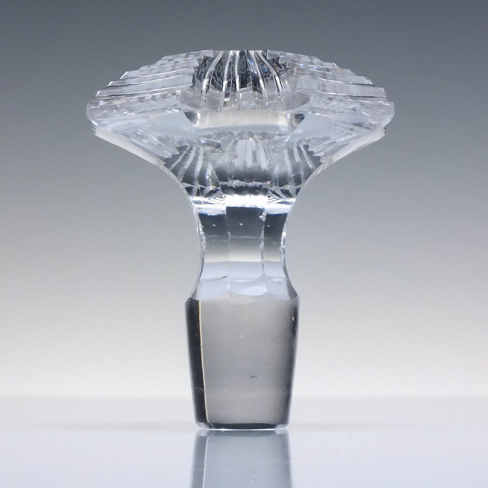 A clear Georgian Regency cut glass claret jug with a step-cut neck, panelled body, applied handle, and faceted stopper. View VIII