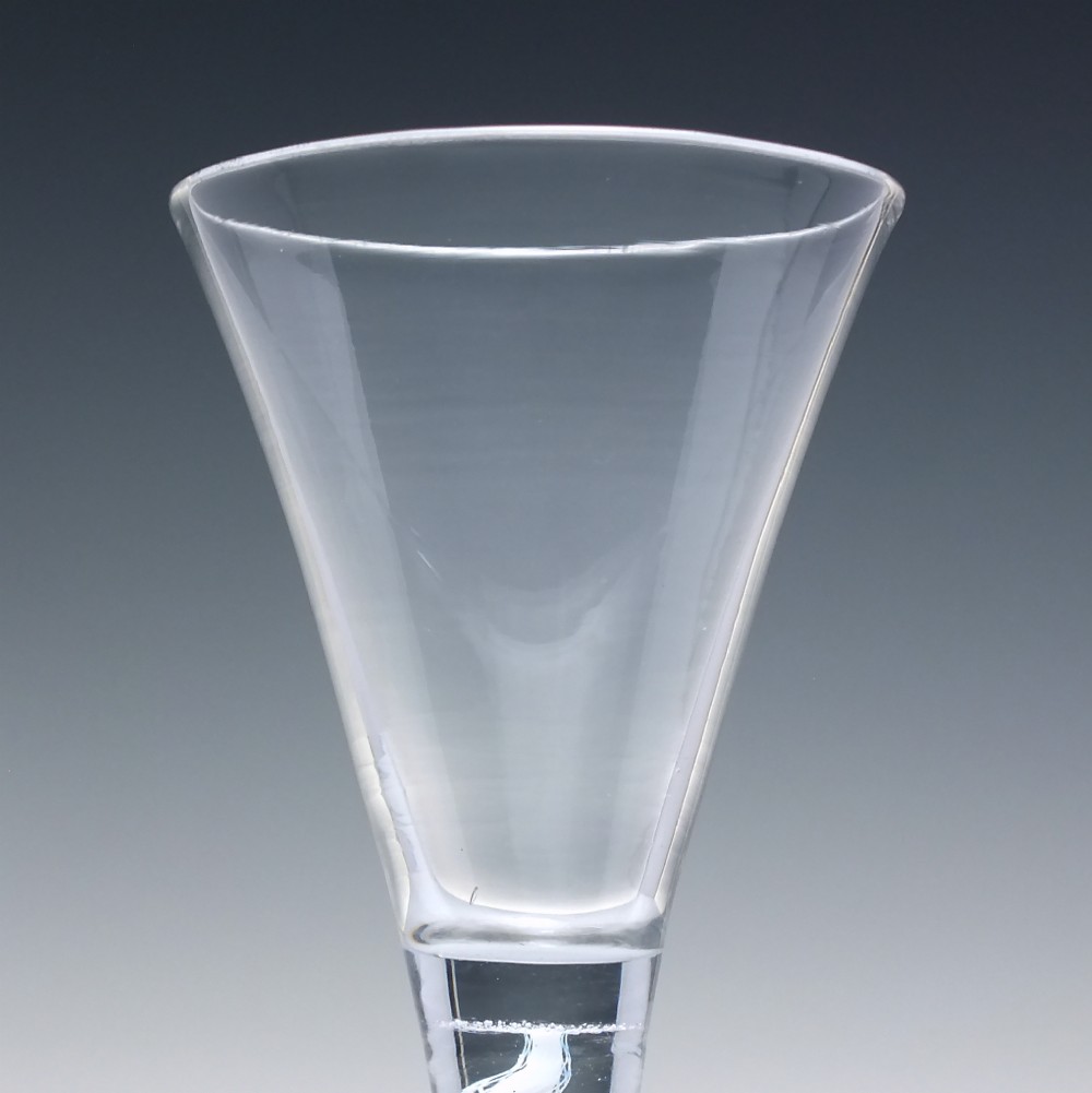 An 18th-century clear lead glass wine glass featuring a flared trumpet bowl, a central white opaque twist stem, and a circular conical foot. View IV