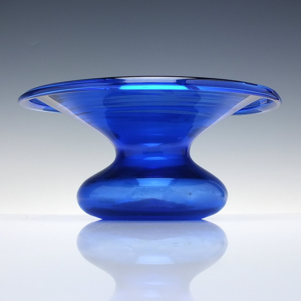 A 19th-century cobalt blue glass spittoon with a wide flared rim and a rounded bulbous base.