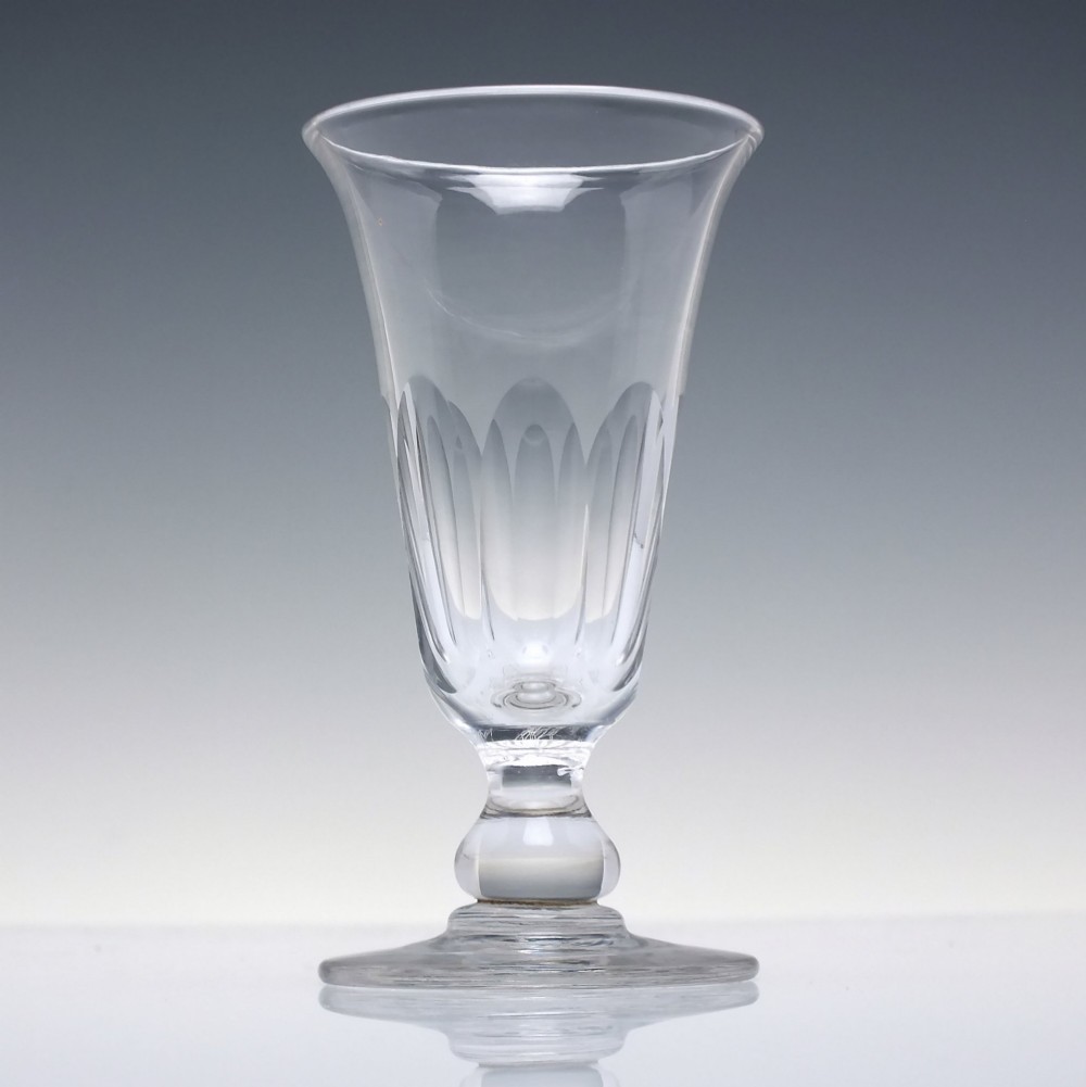 A pair of clear cut-glass Georgian jelly glasses featuring flared rims, panel-cut lower bowls, short knopped stems, and circular flat bases. View III