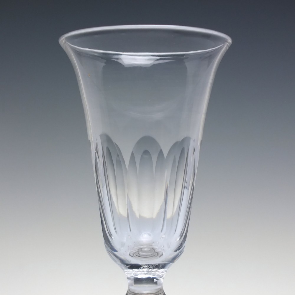 A pair of clear cut-glass Georgian jelly glasses featuring flared rims, panel-cut lower bowls, short knopped stems, and circular flat bases. View IV