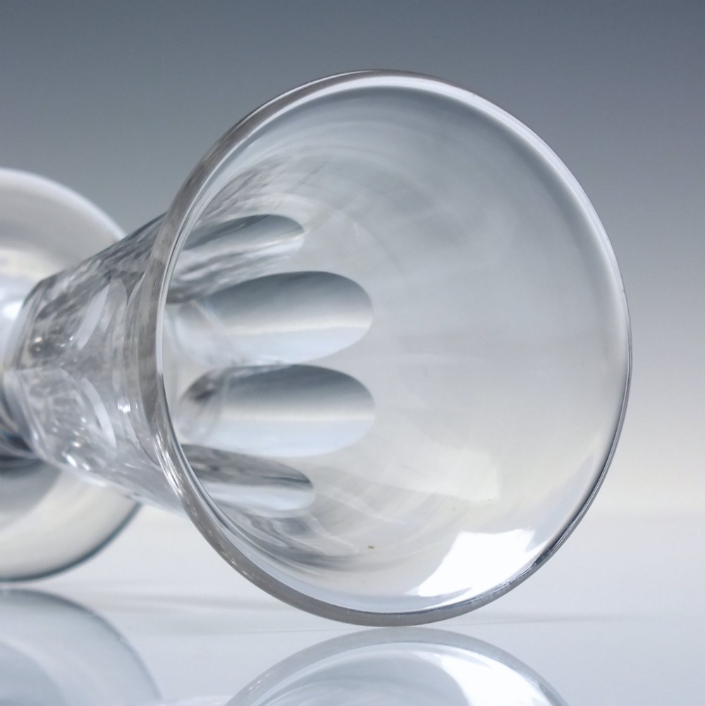 A pair of clear cut-glass Georgian jelly glasses featuring flared rims, panel-cut lower bowls, short knopped stems, and circular flat bases. View V