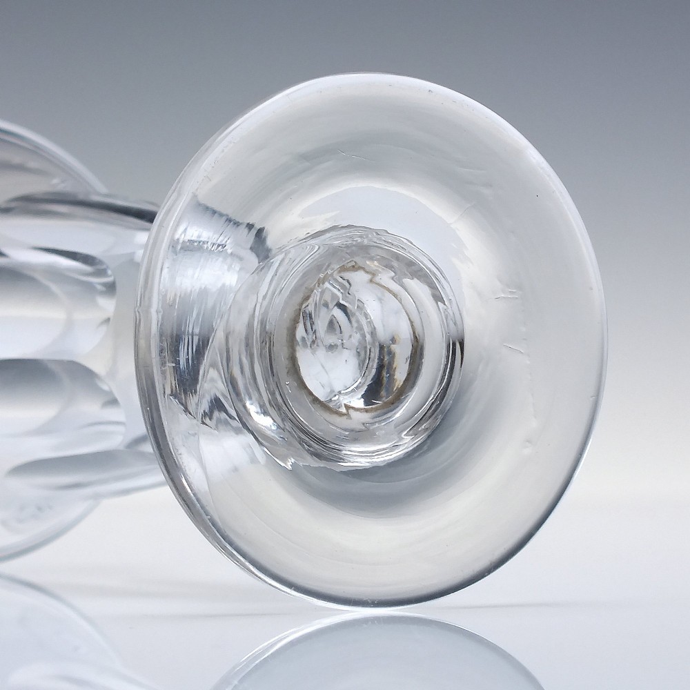 A pair of clear cut-glass Georgian jelly glasses featuring flared rims, panel-cut lower bowls, short knopped stems, and circular flat bases. View VI