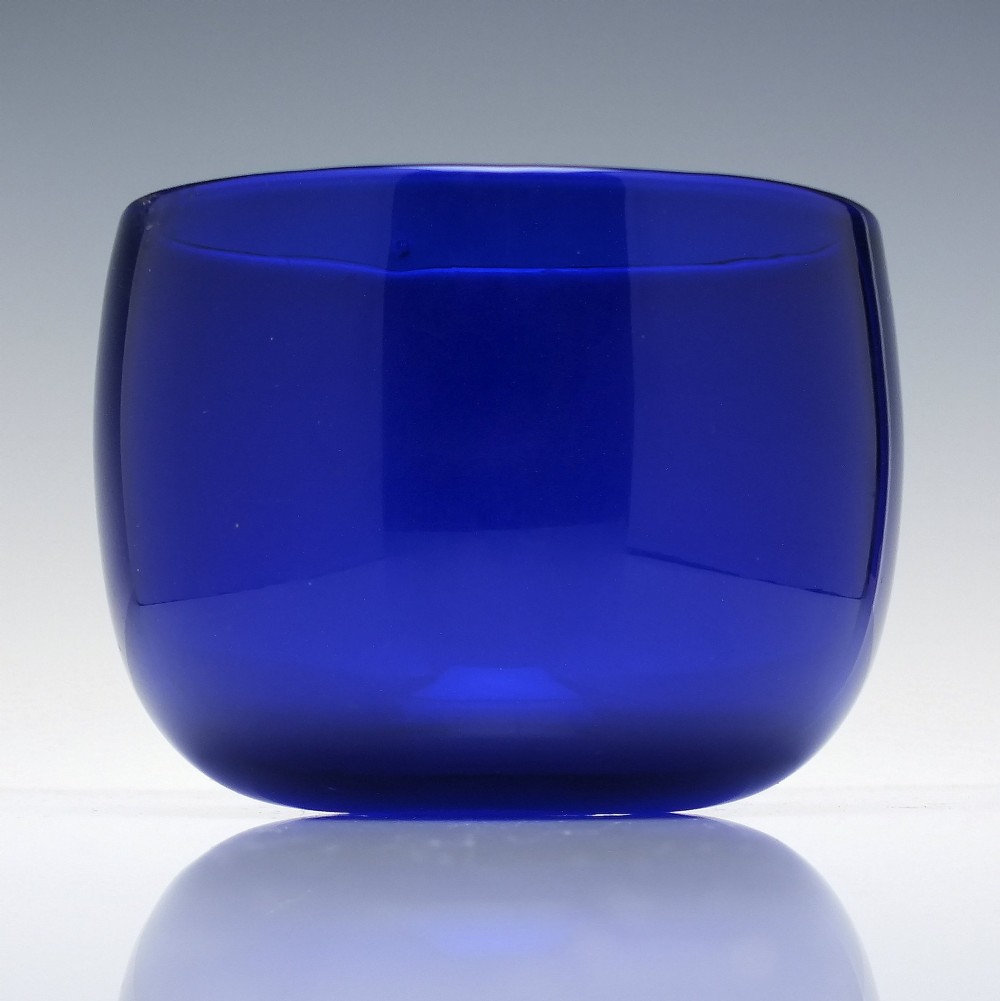 A Victorian cobalt blue glass finger bowl featuring a rounded cylindrical form and a smooth rim.