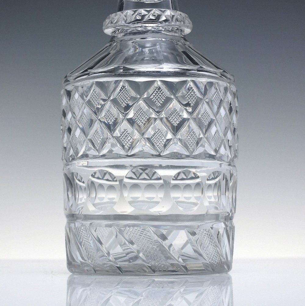 A pair of clear cut lead crystal Georgian decanters featuring diamond cut bands, neck rings, and mushroom stoppers. View III