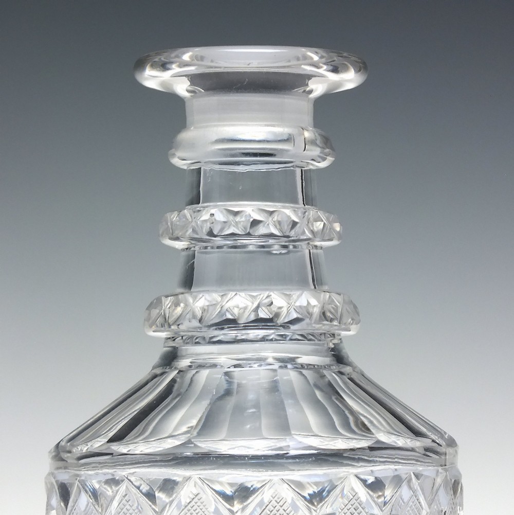 A pair of clear cut lead crystal Georgian decanters featuring diamond cut bands, neck rings, and mushroom stoppers. View IV