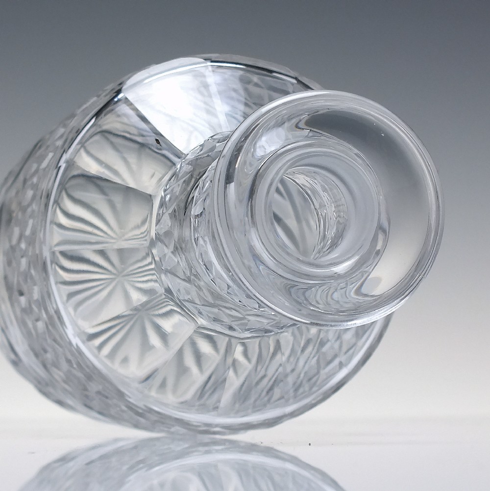 A pair of clear cut lead crystal Georgian decanters featuring diamond cut bands, neck rings, and mushroom stoppers. View V