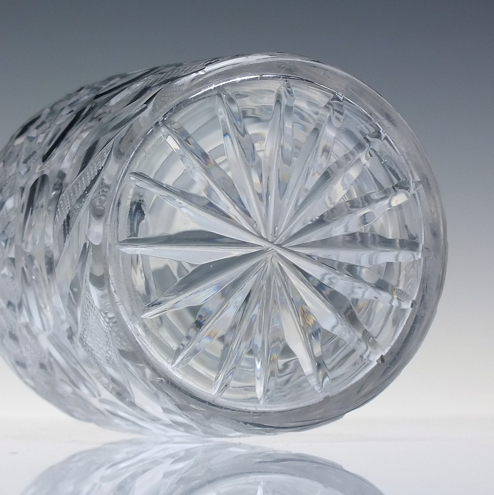 A pair of clear cut lead crystal Georgian decanters featuring diamond cut bands, neck rings, and mushroom stoppers. View VI