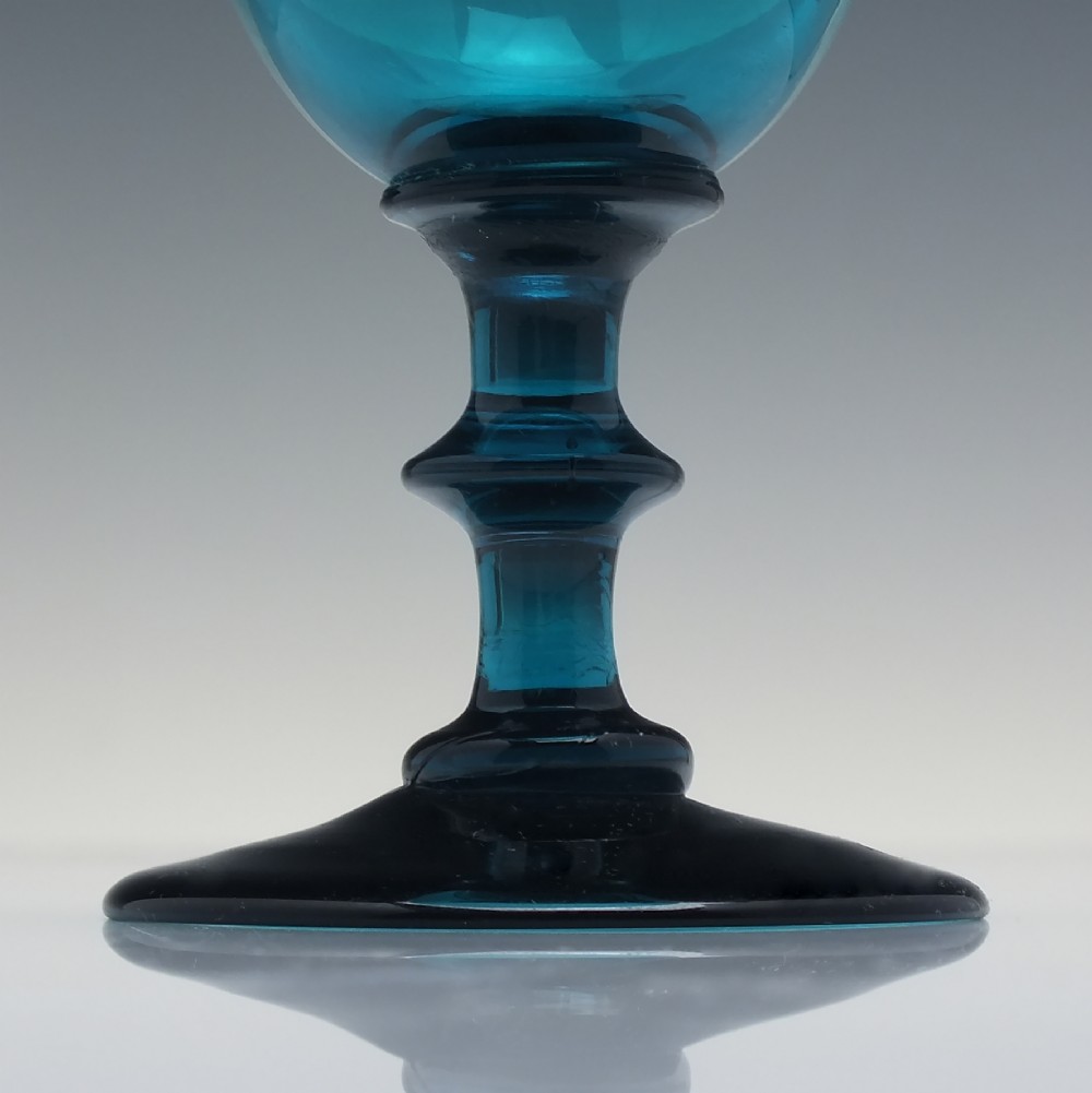 A pair of Georgian teal blue hand-blown glass wine goblets featuring knopped stems and circular bases. View IV