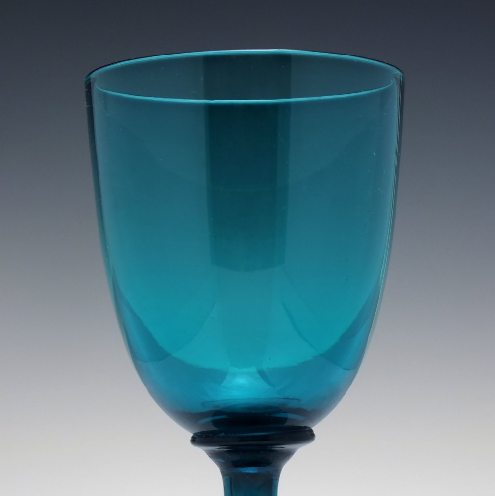 A pair of Georgian teal blue hand-blown glass wine goblets featuring knopped stems and circular bases. View V
