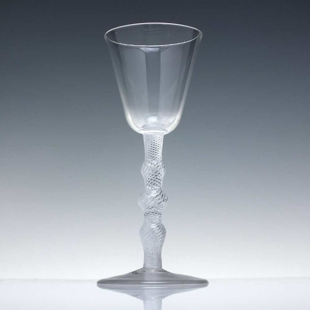 An 18th-century clear lead glass wine glass featuring a knopped air twist stem and a bell-shaped bowl supported by a conical foot. View II