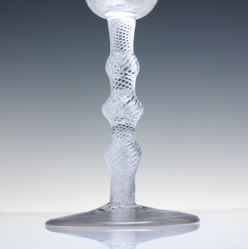An 18th-century clear lead glass wine glass featuring a knopped air twist stem and a bell-shaped bowl supported by a conical foot. View III
