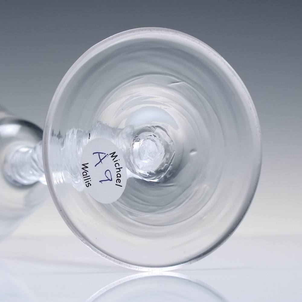 An 18th-century clear lead glass wine glass featuring a knopped air twist stem and a bell-shaped bowl supported by a conical foot. View VI