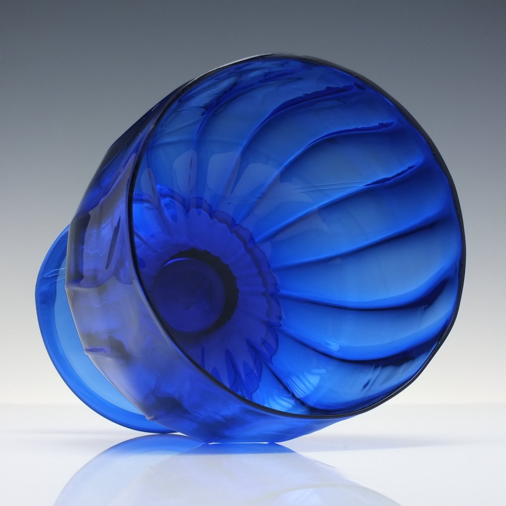 A deep cobalt blue glass sugar bowl featuring a vertically ribbed body set upon a conical pedestal foot. View III